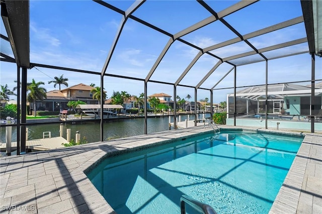 view of pool with a water view, a lanai, a patio, and a dock