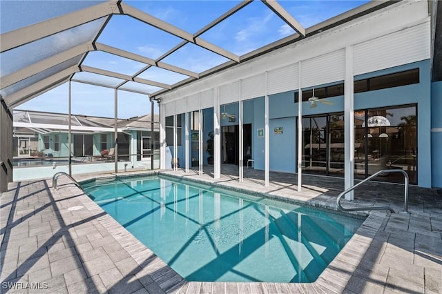 view of pool featuring a patio area, ceiling fan, and glass enclosure