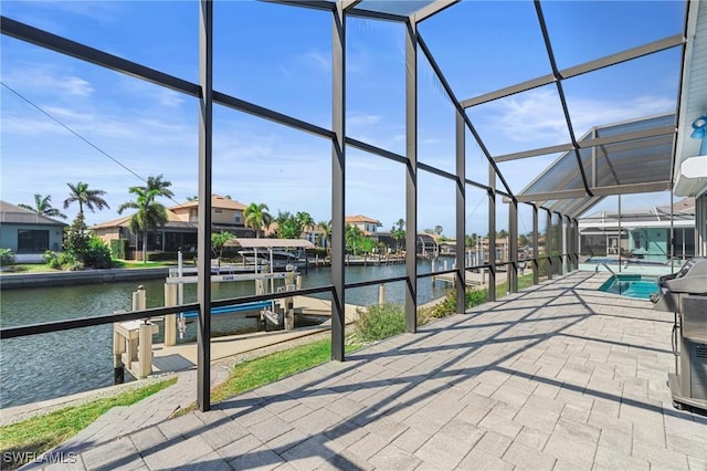 exterior space featuring a lanai, a dock, and a water view