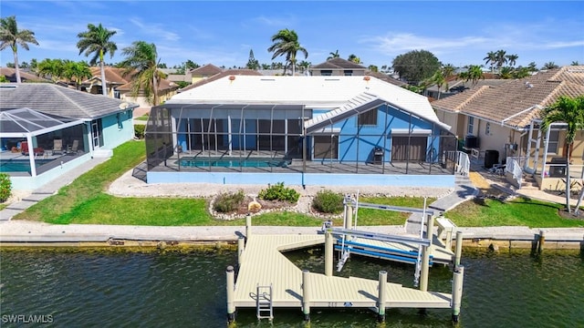 back of property featuring a water view, a lanai, a yard, and a patio area