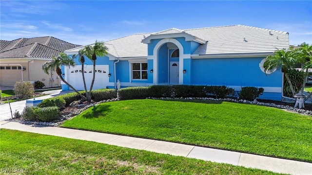 view of front of home with a garage and a front yard