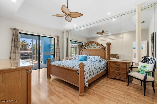 bedroom with decorative columns, ceiling fan, access to outside, and light hardwood / wood-style floors