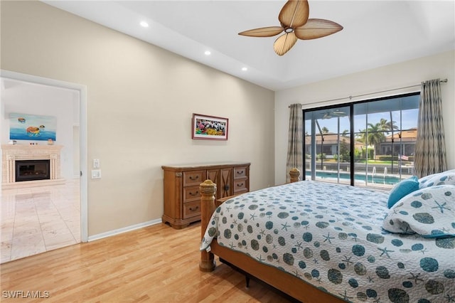 bedroom with ceiling fan, access to outside, and light hardwood / wood-style floors