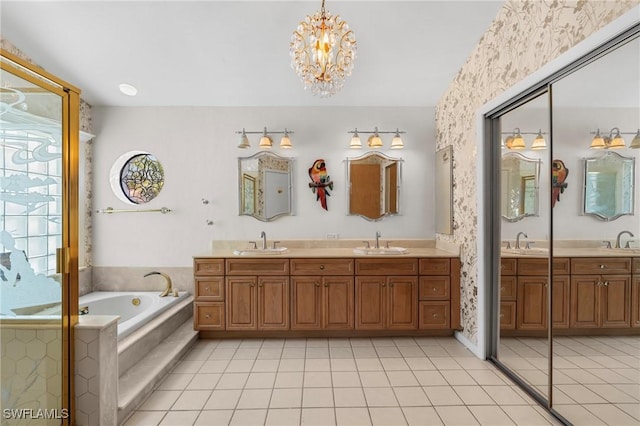 bathroom featuring tile patterned floors, tiled bath, a chandelier, and vanity