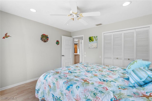 bedroom featuring light hardwood / wood-style flooring, a closet, and ceiling fan