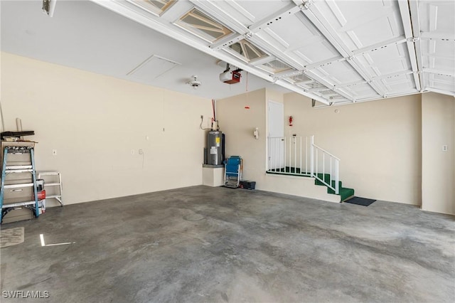 garage featuring a garage door opener and electric water heater