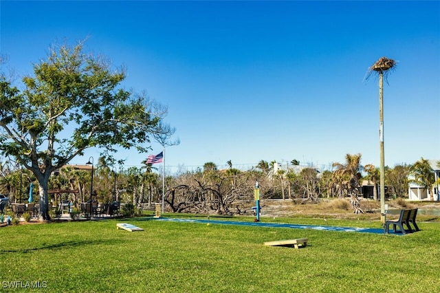 view of property's community with a lawn