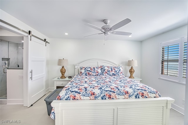 bedroom with ceiling fan and a barn door