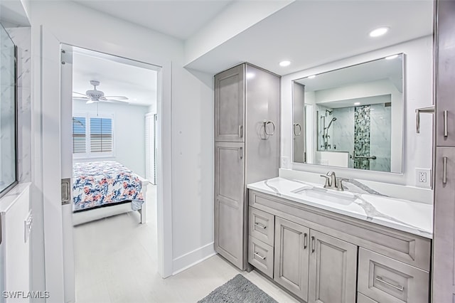 bathroom with vanity, ceiling fan, and a shower with shower door