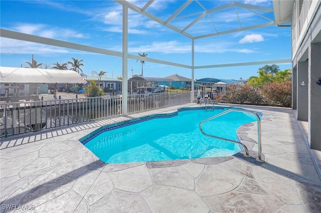 view of pool featuring a lanai, a patio, a fenced in pool, and a residential view