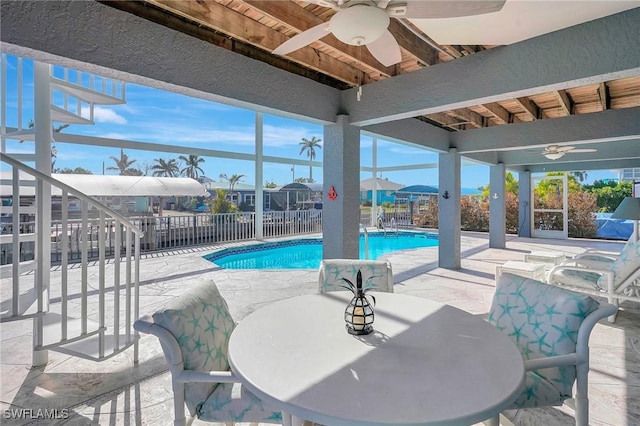view of pool featuring ceiling fan, a patio, and outdoor dining area