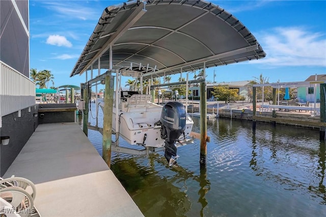 dock area with a water view and boat lift