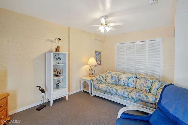 living room with carpet flooring, baseboards, and ceiling fan