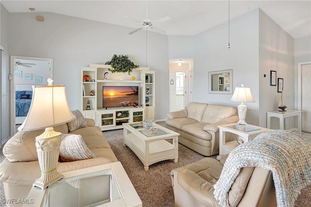 carpeted living room with high vaulted ceiling and a ceiling fan