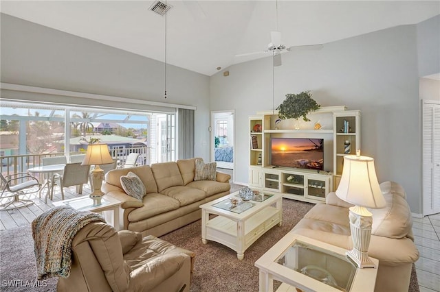 living room with visible vents, high vaulted ceiling, and a ceiling fan