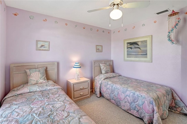 bedroom featuring visible vents, a ceiling fan, and light carpet
