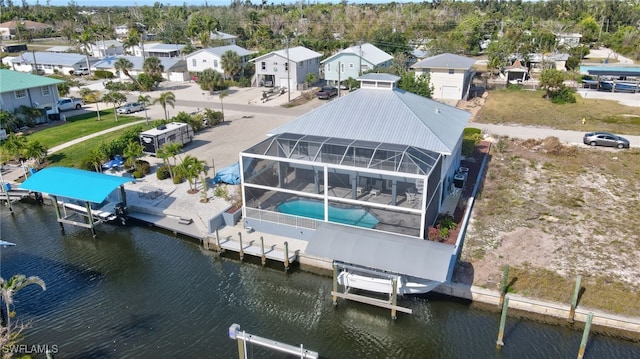 birds eye view of property featuring a water view and a residential view