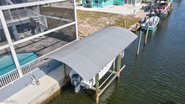 view of dock featuring boat lift and a water view