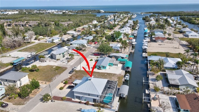 bird's eye view with a water view and a residential view