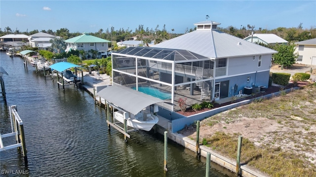 back of house featuring a fenced in pool, a patio, boat lift, a lanai, and a water view
