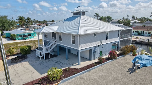 back of property with a carport and metal roof