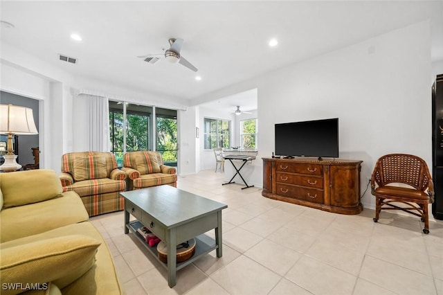 tiled living room with ceiling fan