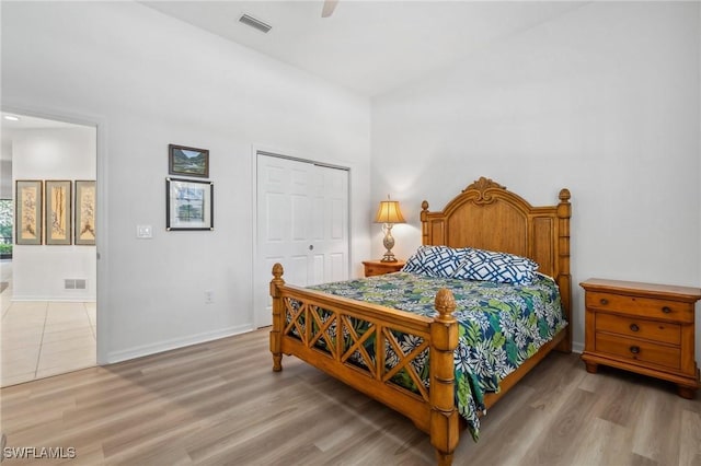 bedroom with hardwood / wood-style floors, a closet, and ceiling fan