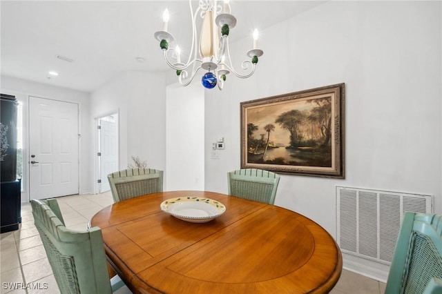 tiled dining space with an inviting chandelier