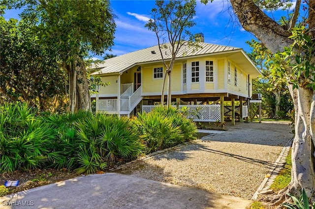 view of front of house featuring a carport and covered porch