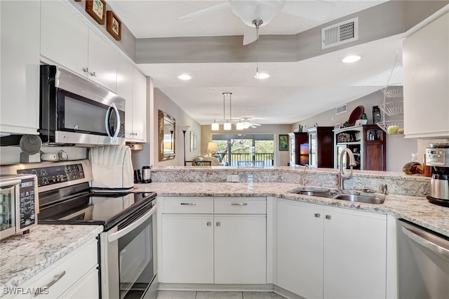 kitchen featuring stainless steel appliances, visible vents, a sink, and a ceiling fan