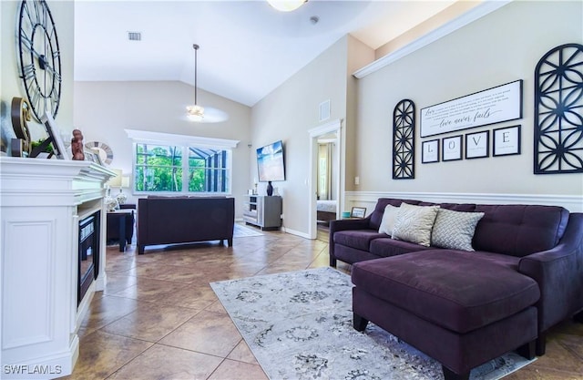 living room featuring high vaulted ceiling and light tile patterned floors