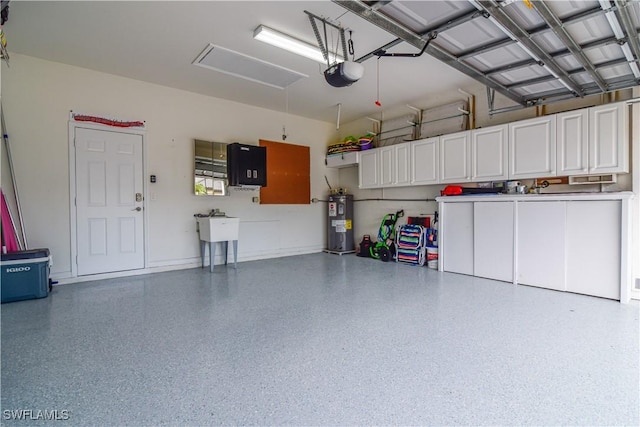 garage with a garage door opener, sink, and electric water heater