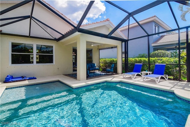 view of pool with ceiling fan, an outdoor living space, a lanai, and a patio area