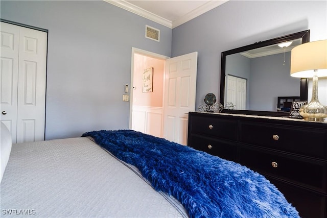 bedroom featuring ornamental molding and a closet