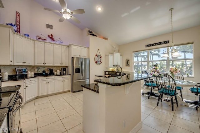 kitchen with appliances with stainless steel finishes, dark stone countertops, visible vents, and white cabinetry