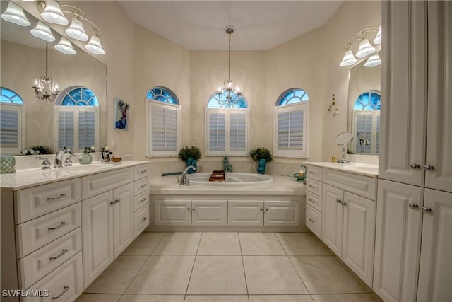 full bath featuring an inviting chandelier, a wealth of natural light, a sink, and tile patterned floors