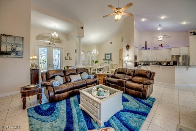 living area featuring high vaulted ceiling, ceiling fan with notable chandelier, french doors, and light tile patterned floors