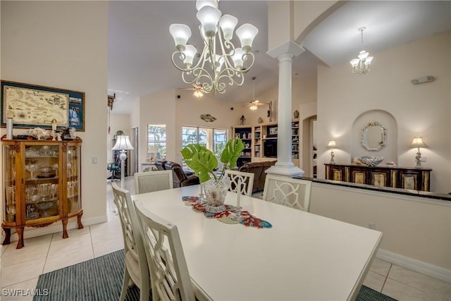 dining area featuring arched walkways, light tile patterned flooring, ornate columns, and ceiling fan with notable chandelier