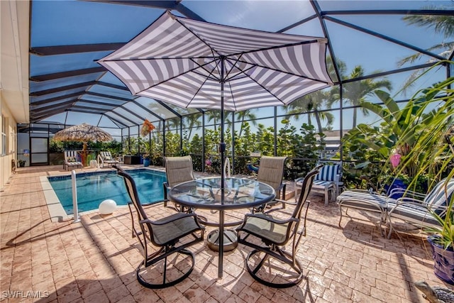 outdoor pool with a lanai and a patio