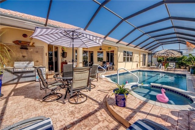 view of pool with glass enclosure, area for grilling, a pool with connected hot tub, a ceiling fan, and a patio area