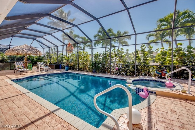 view of swimming pool with a lanai, a patio area, and a pool with connected hot tub