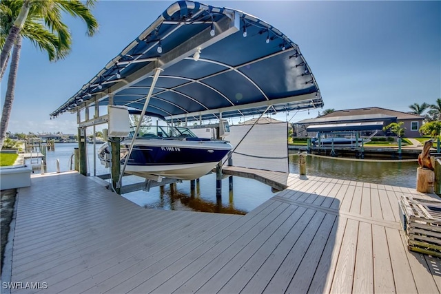 dock area with a water view and boat lift