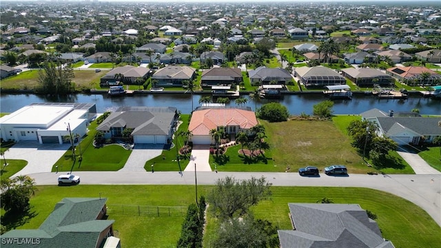 drone / aerial view featuring a residential view and a water view