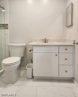 full bathroom featuring marble finish floor, toilet, a stall shower, vanity, and baseboards