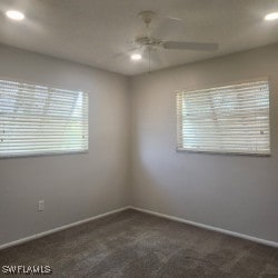 unfurnished room featuring dark colored carpet, recessed lighting, a ceiling fan, and baseboards