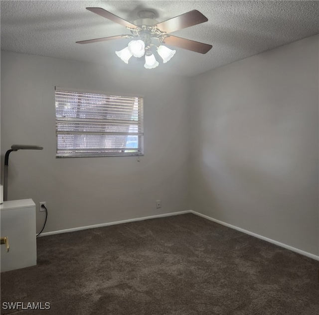 carpeted spare room with ceiling fan, a textured ceiling, and baseboards