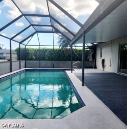 outdoor pool with a lanai and a patio area