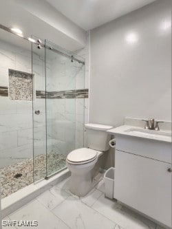 bathroom with a marble finish shower, marble finish floor, vanity, and toilet