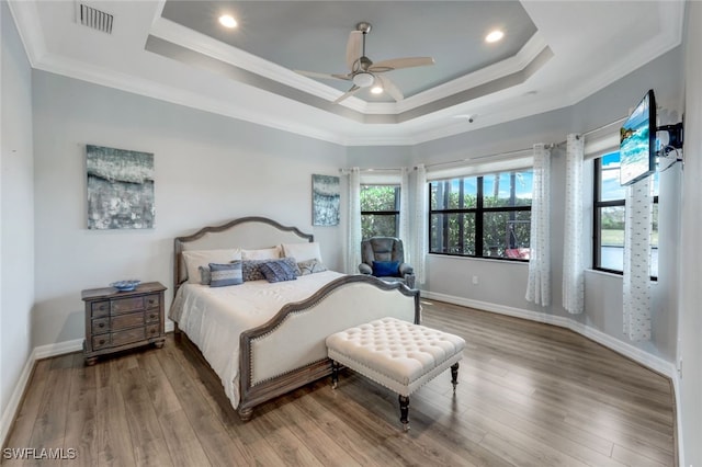 3366 Baltic Dr, Naples, FL 34119 - bedroom with visible vents, crown molding, a tray ceiling, and wood finished floors