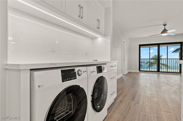 washroom featuring light wood-type flooring, cabinets, independent washer and dryer, and ceiling fan